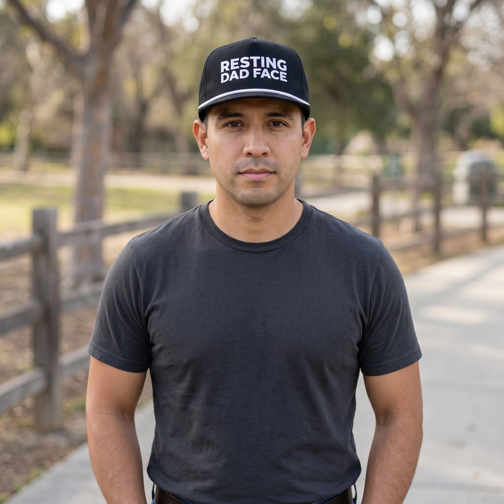 Image of a man wearing a black cap with "Resting Dad Face" embroidery