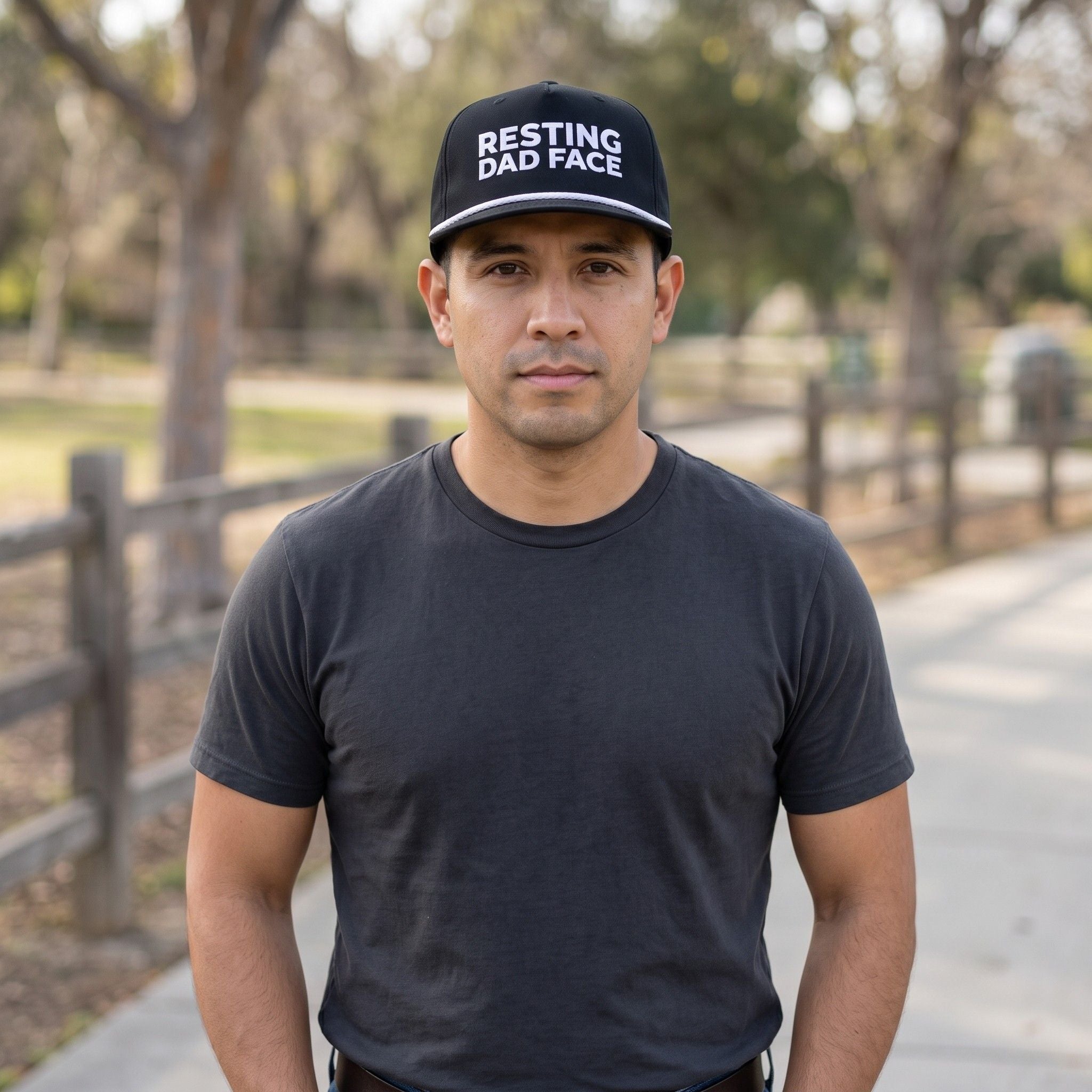 Image of a man wearing a black cap with "Resting Dad Face" embroidery