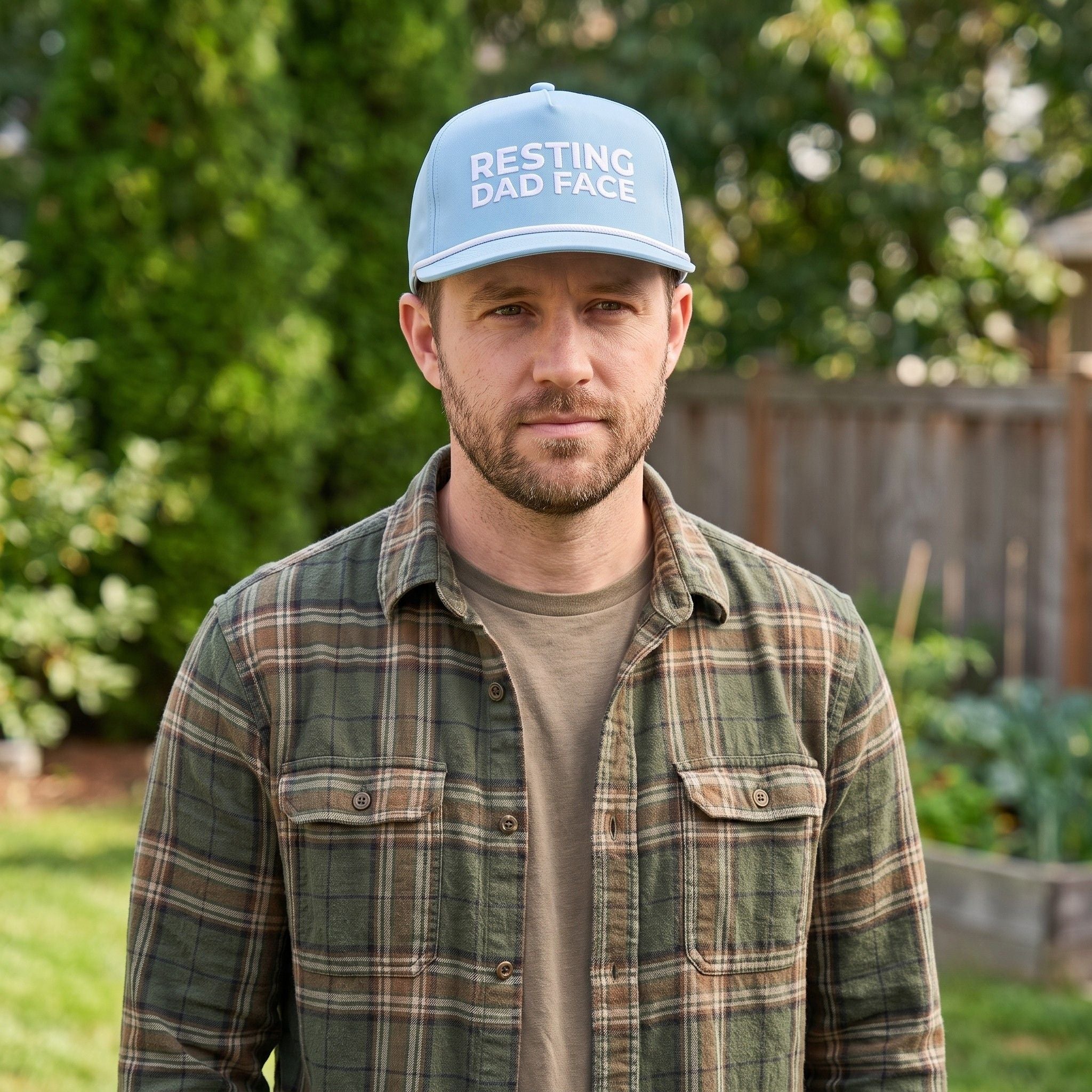 Image of a man wearing a light blue cap with "Resting Dad Face" embroidery