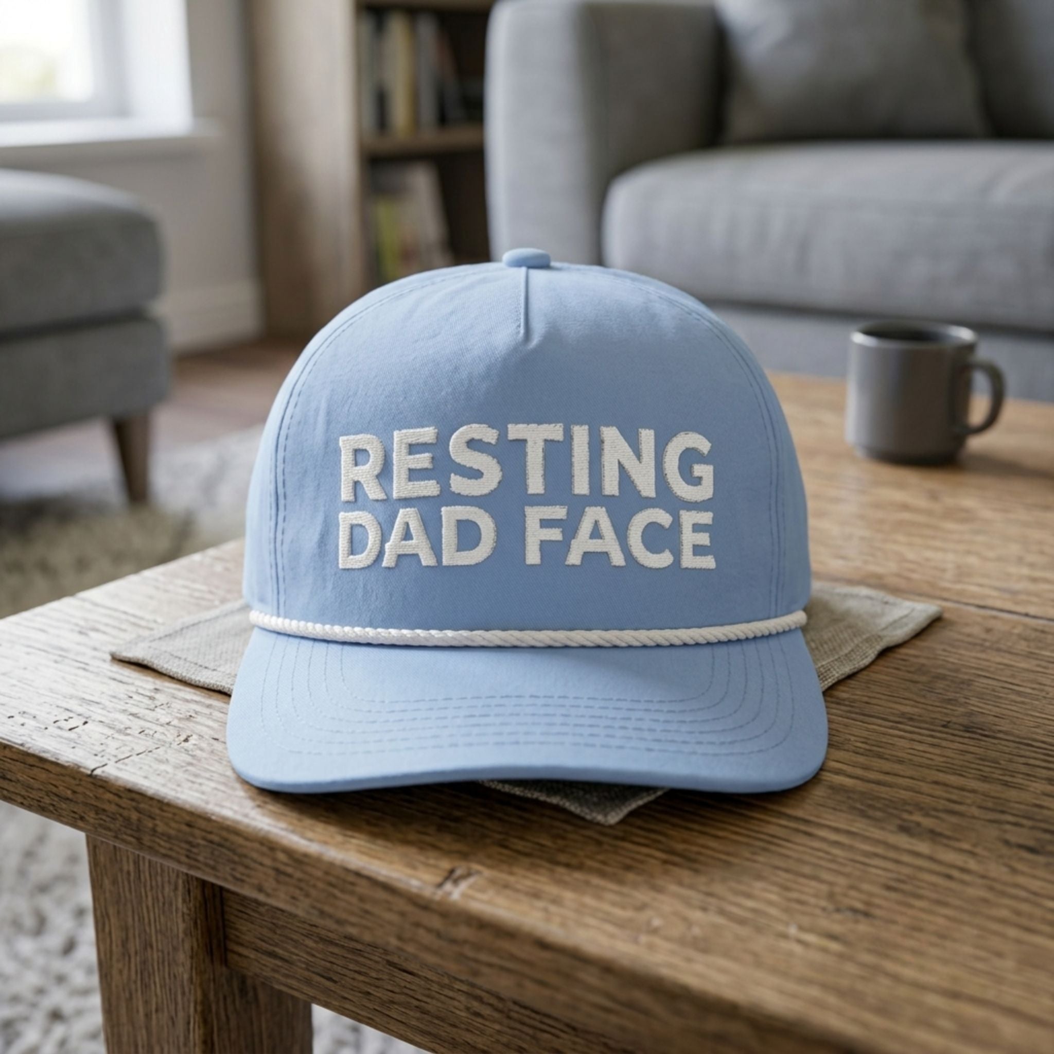 Image of a light blue cap with Resting Dad Face embroidery